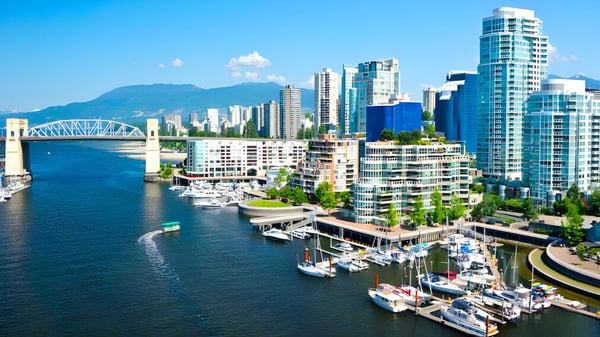 Una vista de ciudad concurrida con rascacielos, puerto y puente bajo un cielo despejado, sin relación directa con la Alpha School.