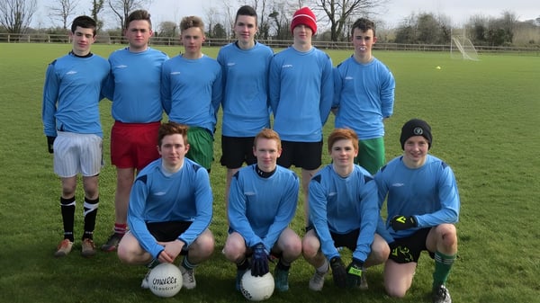 Un grupo de alumnas y alumnos de Coláiste Mhuire Ballymote posan juntos en un campo de fútbol.