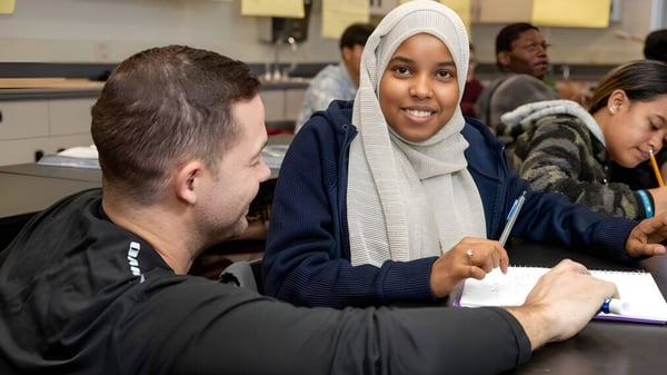 Un grupo de estudiantes se encuentra en una ronda de conversación en el edificio del Denver Public School District.