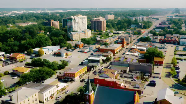 Vista de la ciudad con rascacielos y áreas verdes bajo un cielo claro sin relación directa con la Elsie MacGill Secondary School.