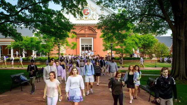 Un grupo de estudiantes camina por un camino de ladrillos frente a un edificio histórico en el campus de Episcopal High School.