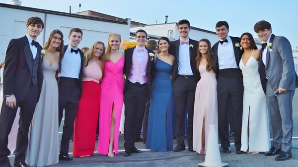 Estudiantes del Fingal Community College posan con ropa formal frente a un edificio.