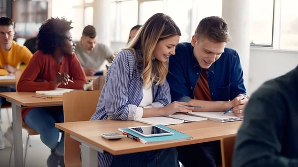 Un grupo de estudiantes de la Gallen Community School está sentado en el aula trabajando juntos en tareas.