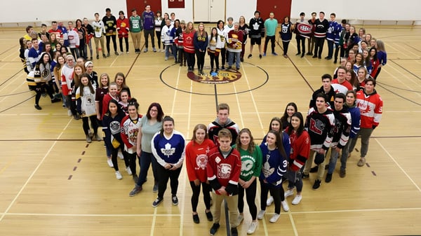 Estudiantes de la Gravenhurst High School forman un corazón con sus cuerpos en el gimnasio.