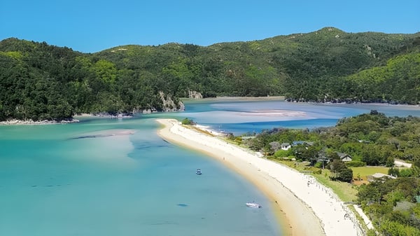 Un pintoresco tramo de costa con playa y colinas verdes cerca del Heretaunga College.