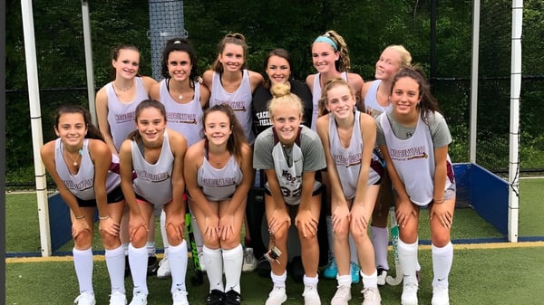 Un grupo de jóvenes atletas está en el campo deportivo de la Newburyport High School.