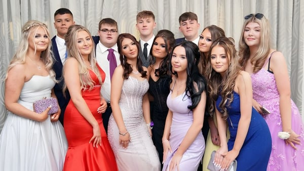 Un grupo de estudiantes del Our Lady Catholic College posan juntos frente a una cortina.