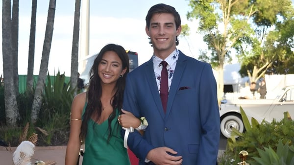 Una joven pareja está junta en un área similar a un jardín en el terreno de la Pacific Lutheran High School.