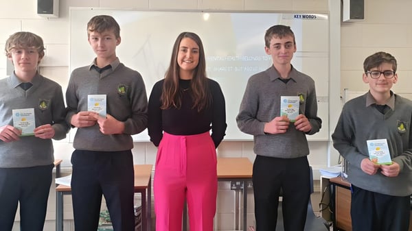 Estudiantes del Rice College están en el aula sosteniendo certificados en sus manos.