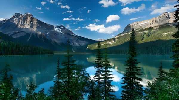 Un tranquilo lago alpino con montañas cubiertas de nieve y bosque se refleja en el agua cerca de la Seaquam Secondary School.