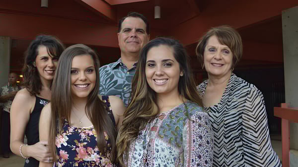 Un grupo de cinco estudiantes posa sonriendo en un café en el campus de la St. Anthony School.