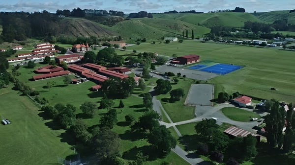 Una cancha de tenis está incrustada en el paisaje verde en el campus de St. Kevin’s College.