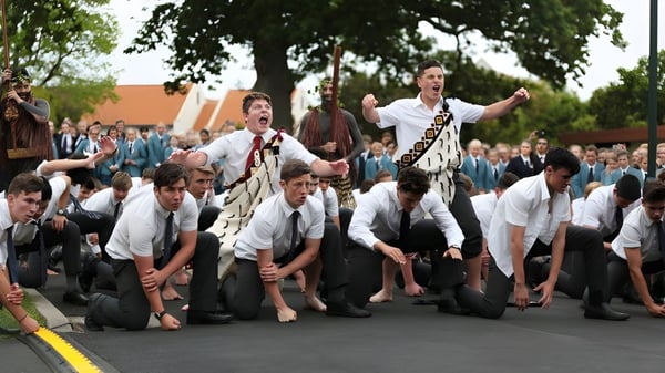 Un grupo de estudiantes de la St. Peter's School Cambridge está de pie y arrodillado juntos afuera bajo un gran árbol.