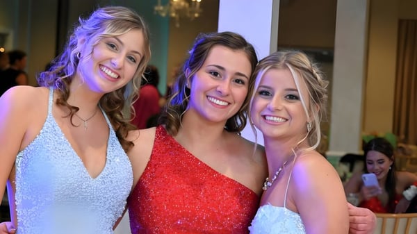 Tres alumnas de la Tecumseh Vista Academy sonríen juntas en un evento escolar.