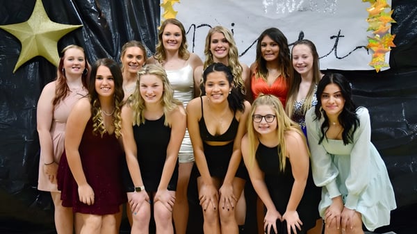 Un grupo de estudiantes se encuentra junto a un fondo de estrellas y cruces en la Thunder Ridge High School.